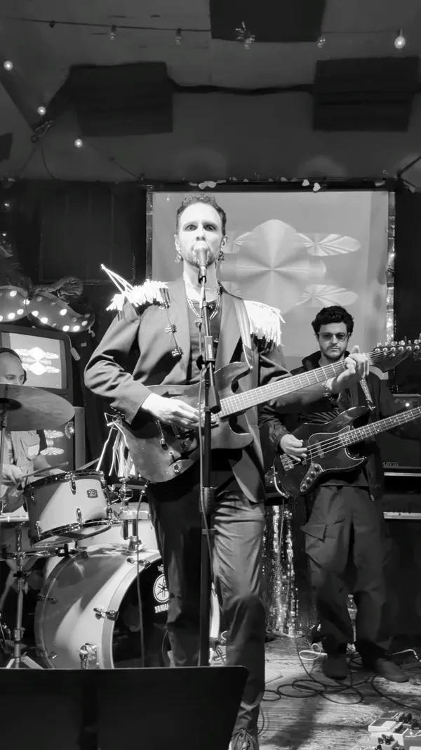Black and white shot of the band performing on stage