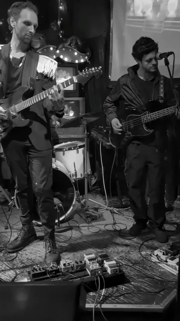 Black and white shot of the band performing on stage